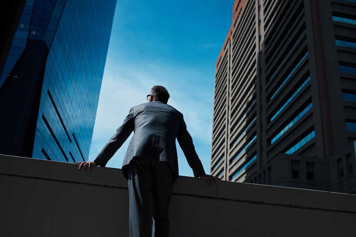Business man and thinking at city on rooftop